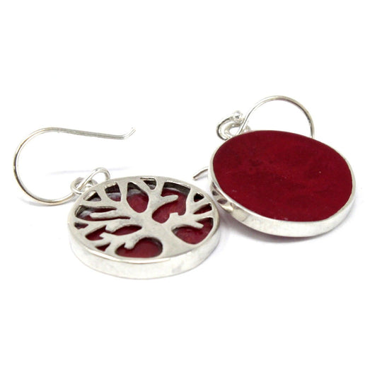 Close-up Levensboom symbool in sterling zilver oorbellen met warme koraalrode details
