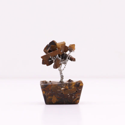 Detail shot of mini tiger eye gemstone tree showing golden crystal chips with distinctive bands and small orgonite base, handcrafted pocket-sized confidence piece

